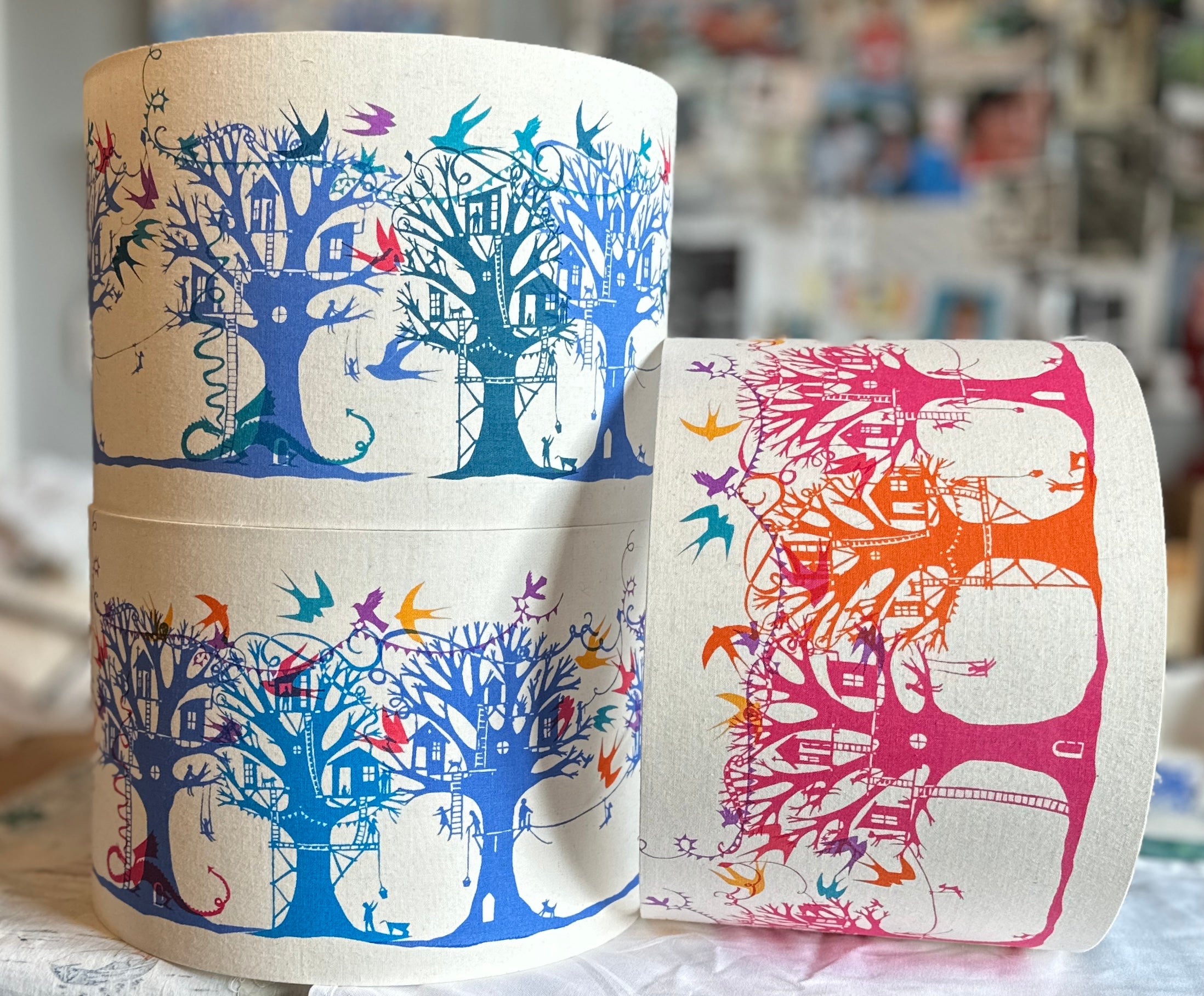 Three treehouse lampsahdes in blue pink and orange on a natural background