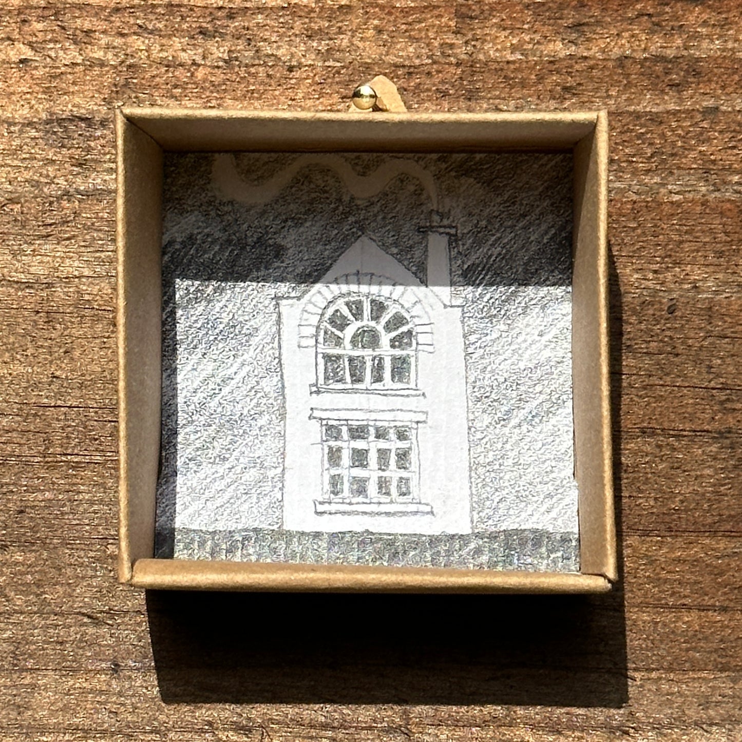  Display box for handmade paper house on plywood base.