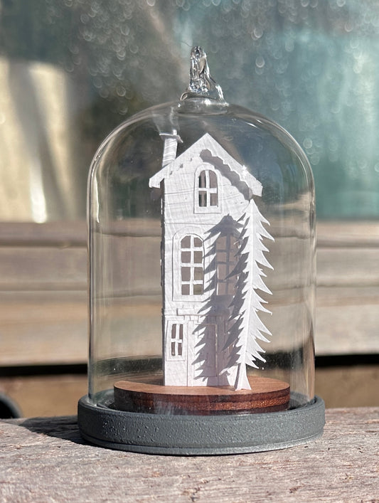 miniature paper house in glass dome 