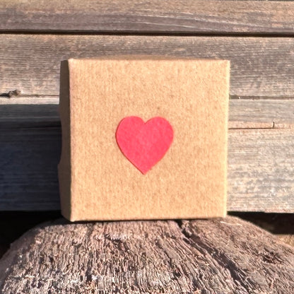 Front of brown card presentation box with applied Red Heart 