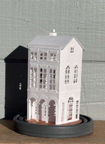 three storey paper house with triple arched colonnade on grey painted base 