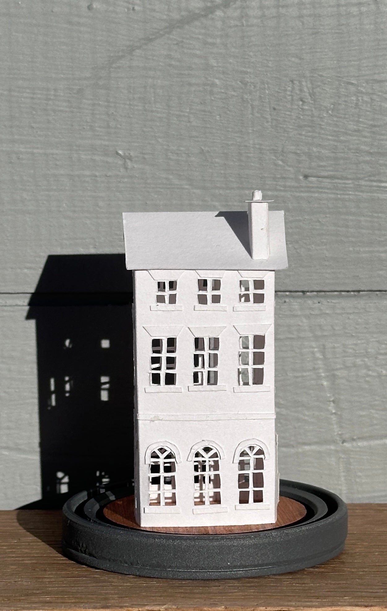 three storey paper house with triple arched colonnade on grey painted base  rear elevation
