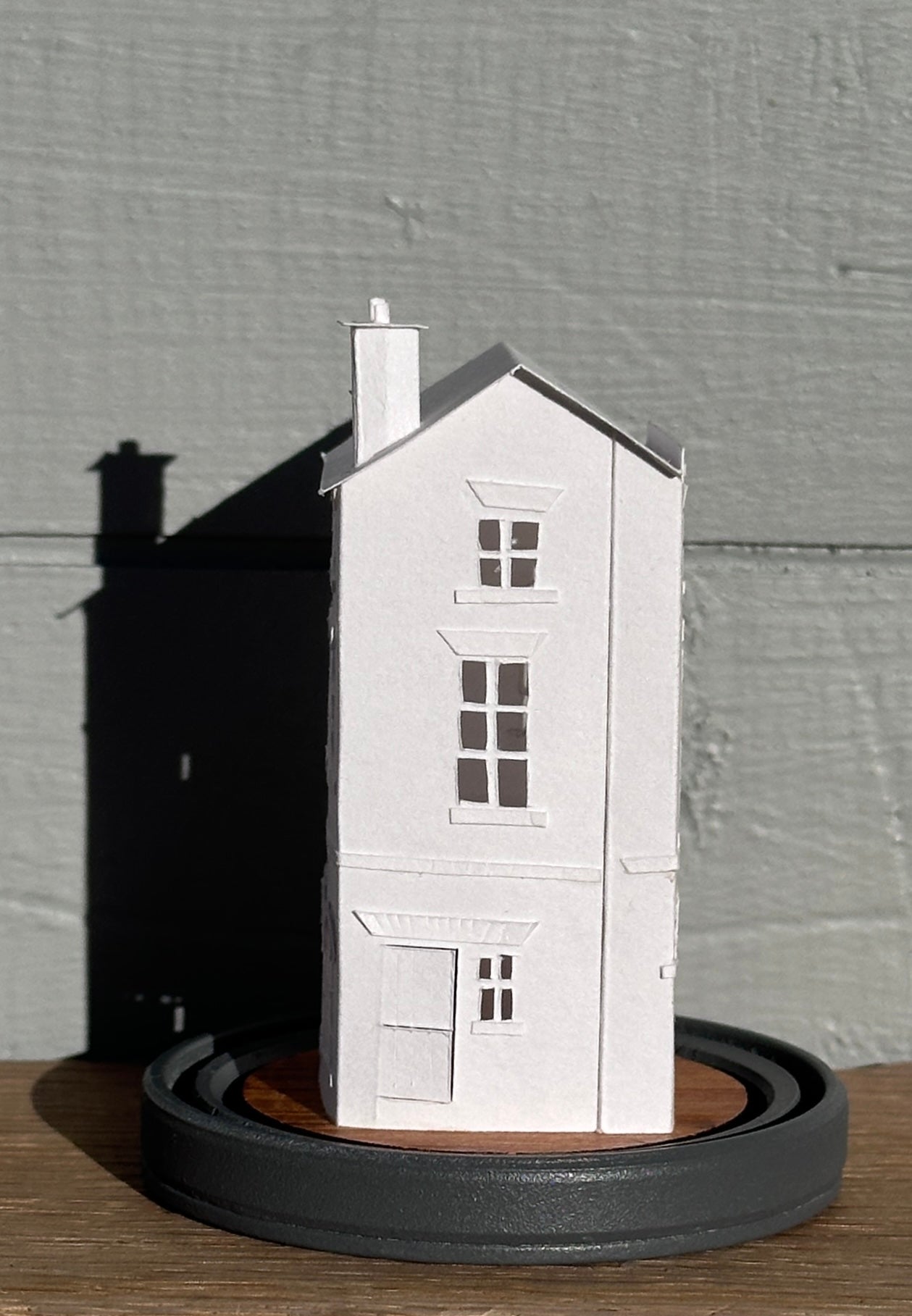 three storey paper house with triple arched colonnade on grey painted base  side view
