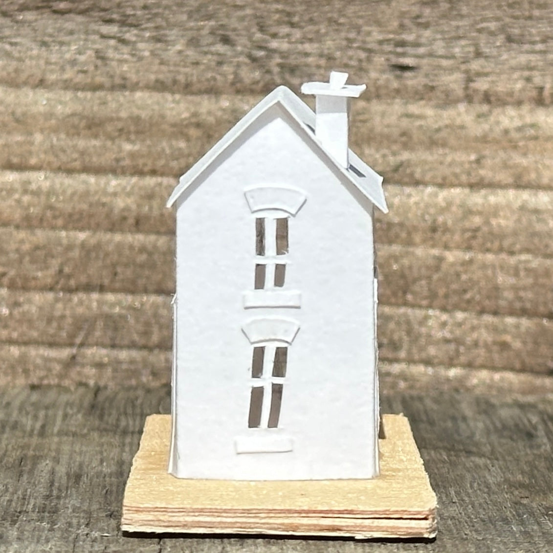white paper coach house on plywood base
