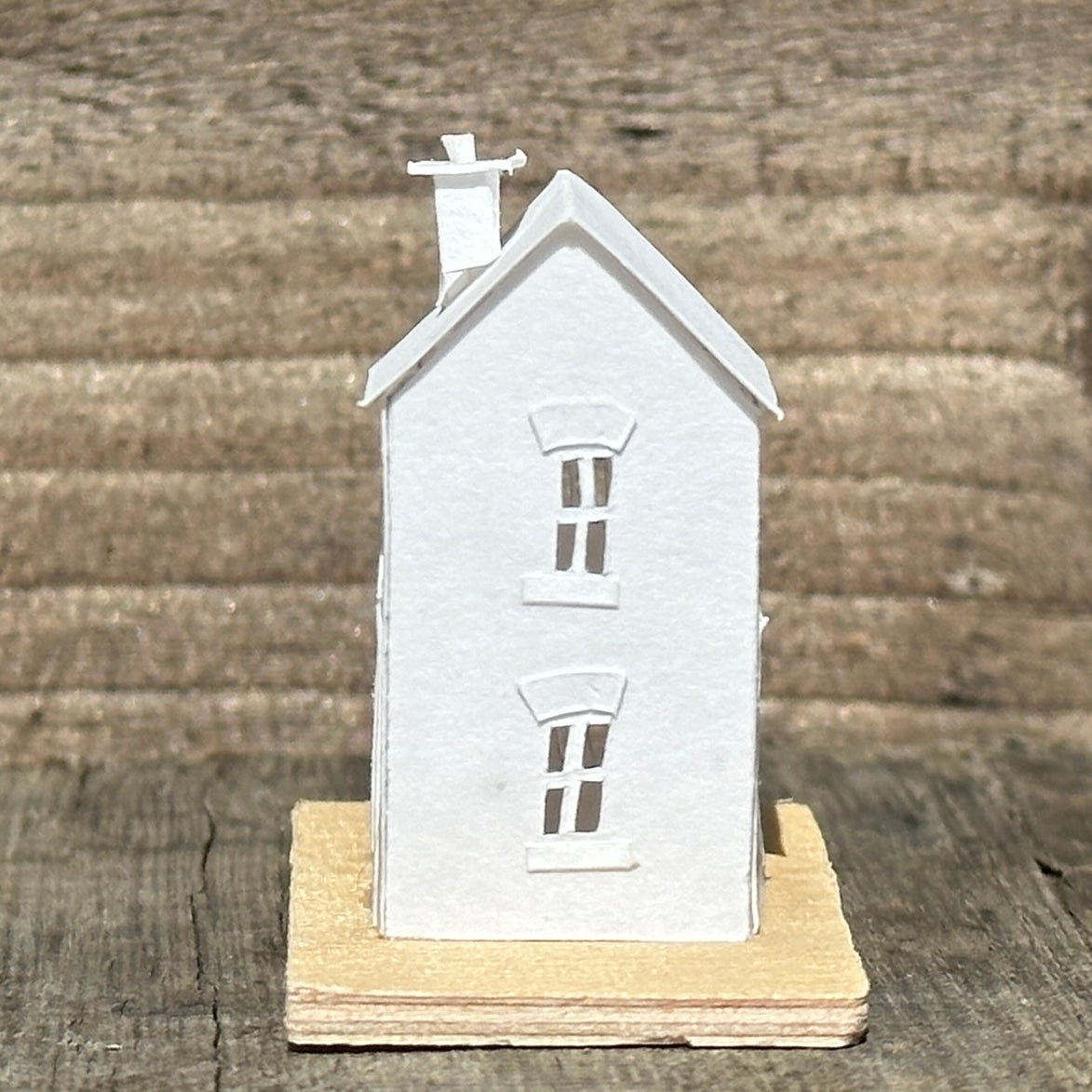 white paper coach house on plywood base