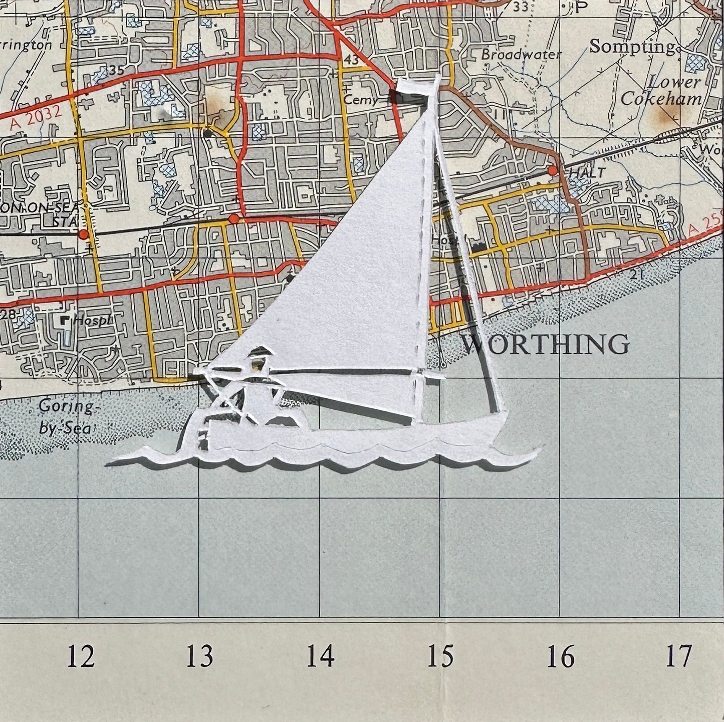 papercut sailing boat over OS map extract