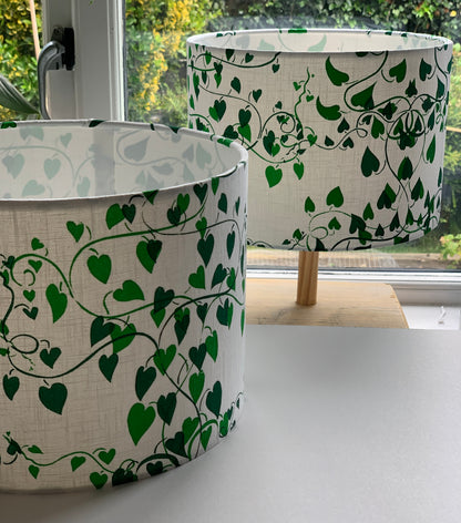 Two shades of green on white fabric  handprinted lampshades in  a convolvulus design.