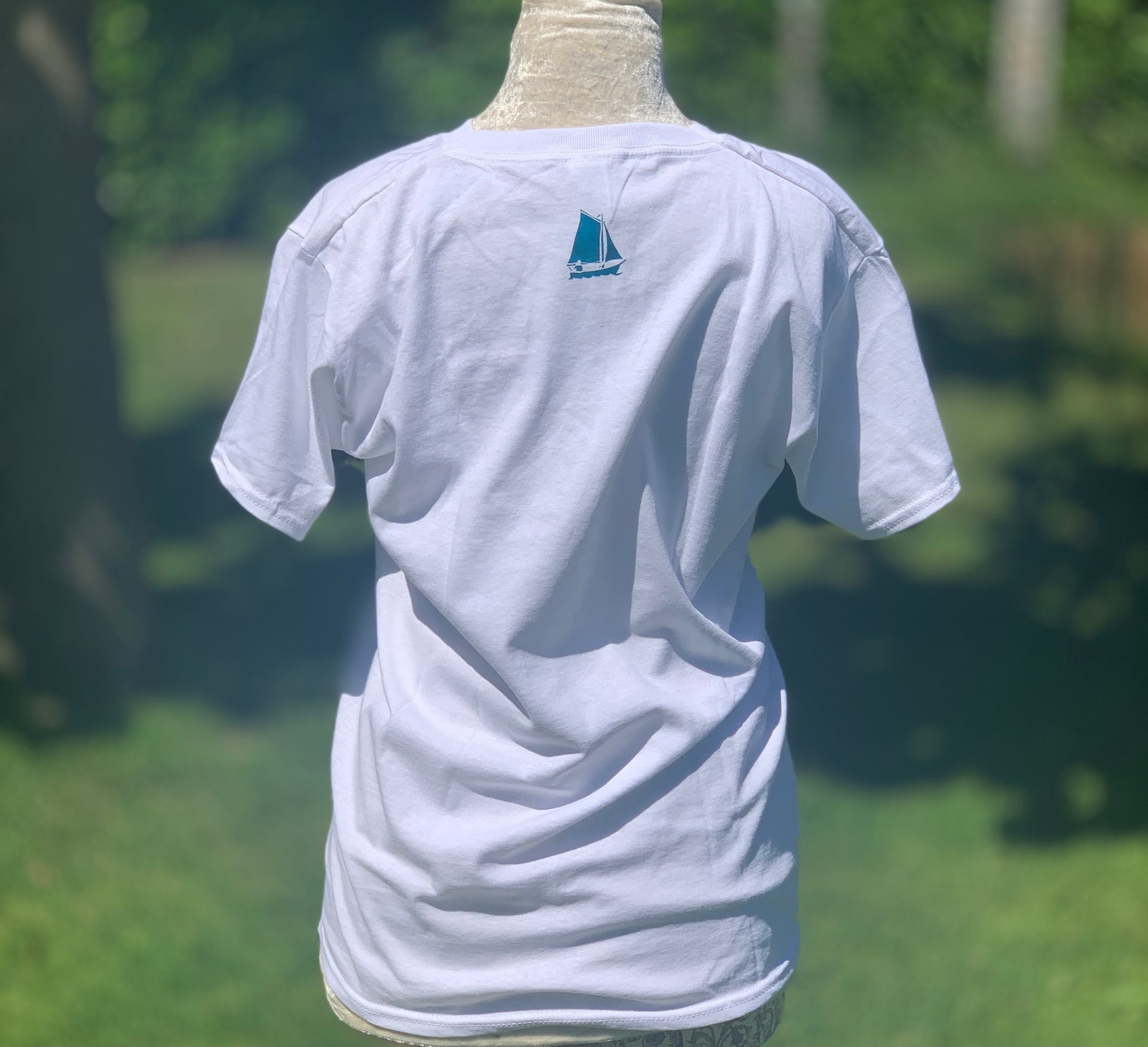 Back of white T-shirt with turquoise blue design of boat at neck line.