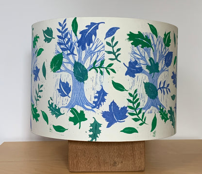 Blue and green handprinted lampshade featuring trees and leaves.