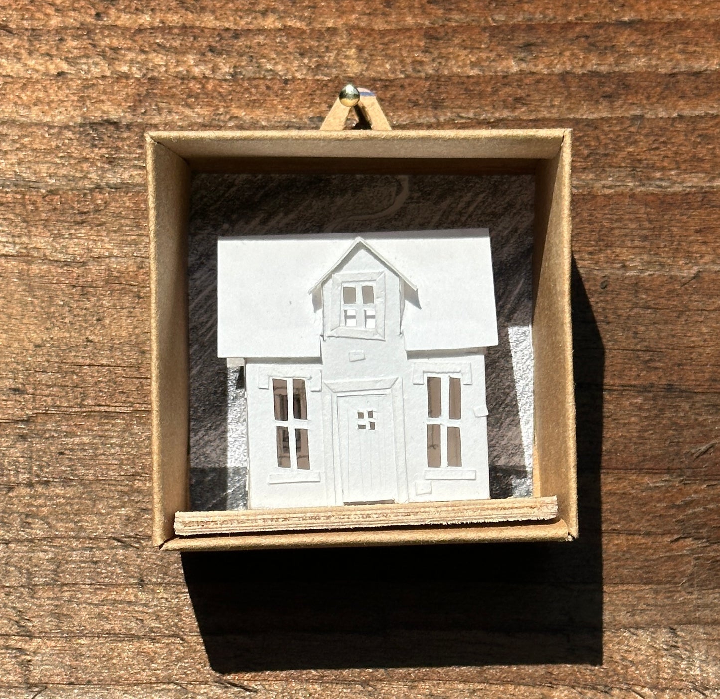  MiniatureMiniature  handmade paper house on plywood base in card display box.