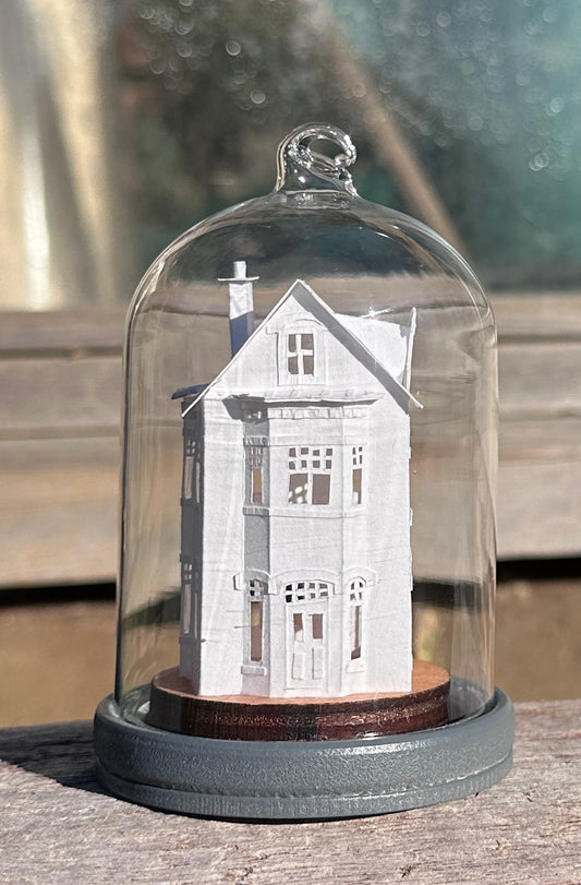 miniature paper house in glass dome
