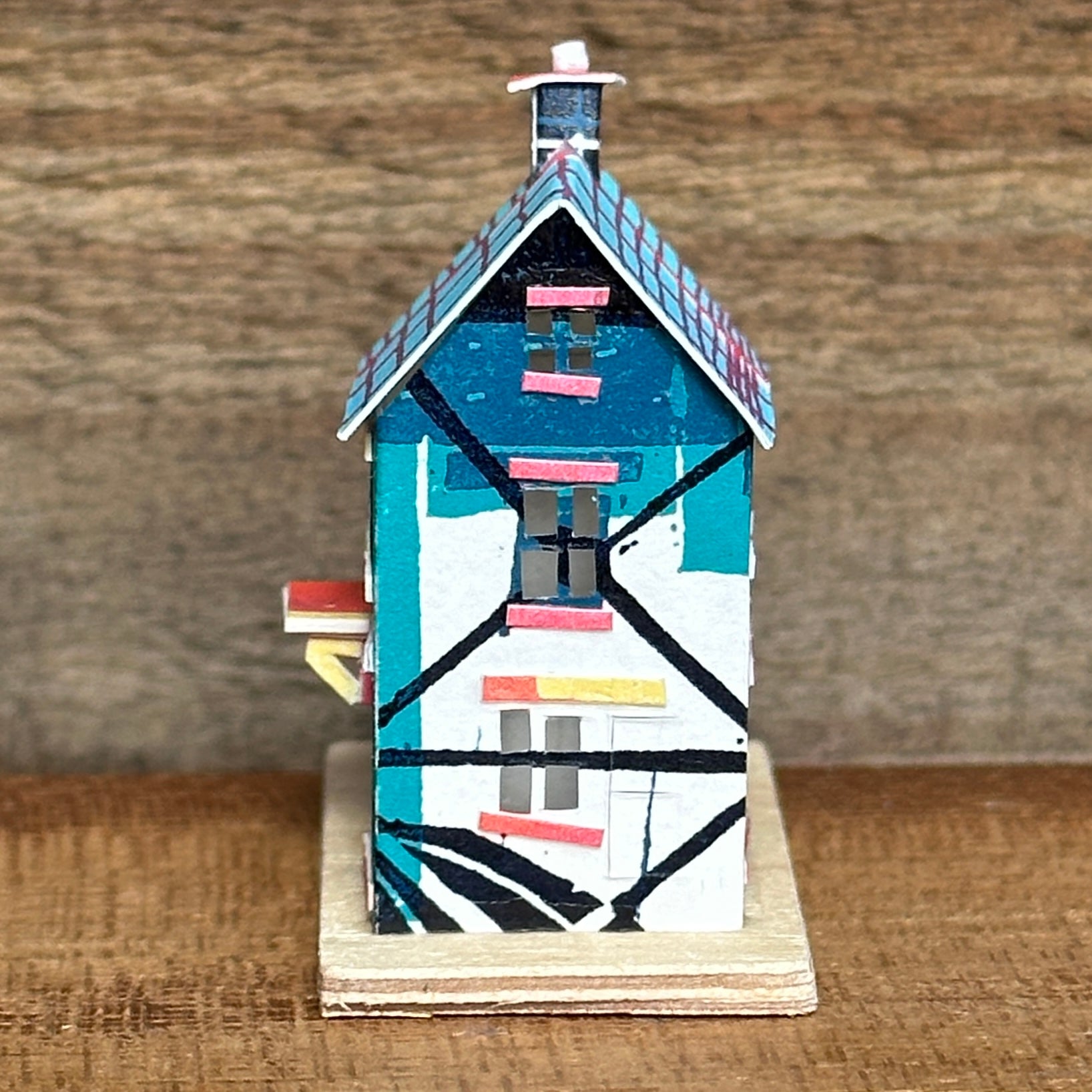 olourful blue and pink house with curved roof extension