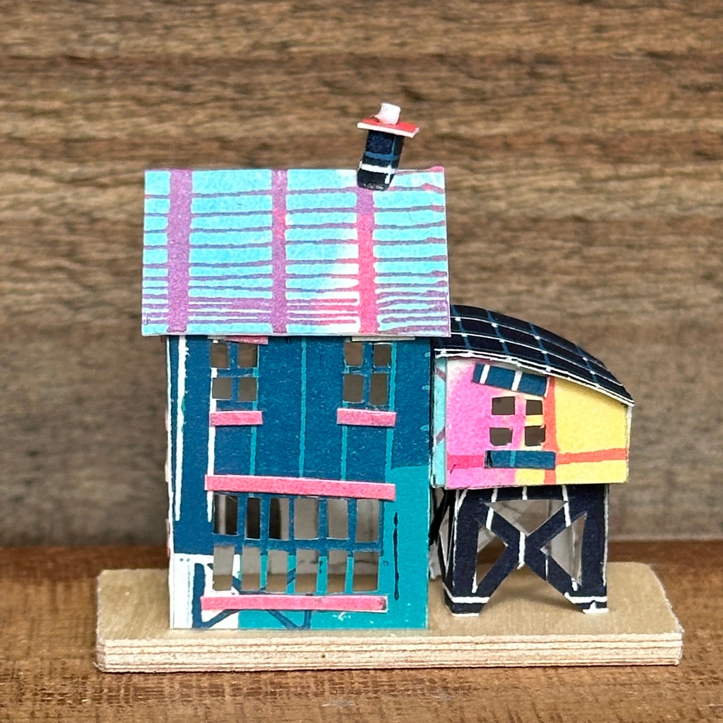 olourful blue and pink house with curved roof extension