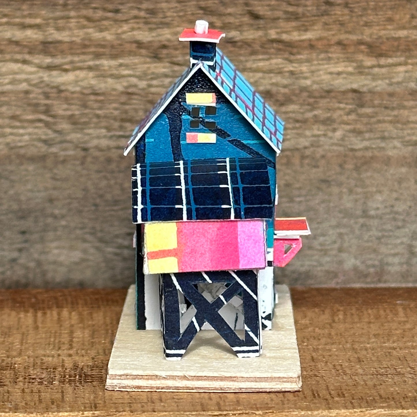 olourful blue and pink house with curved roof extension